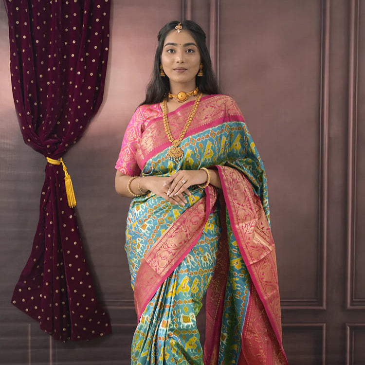 Woman wearing a colorful saree with a decorative background